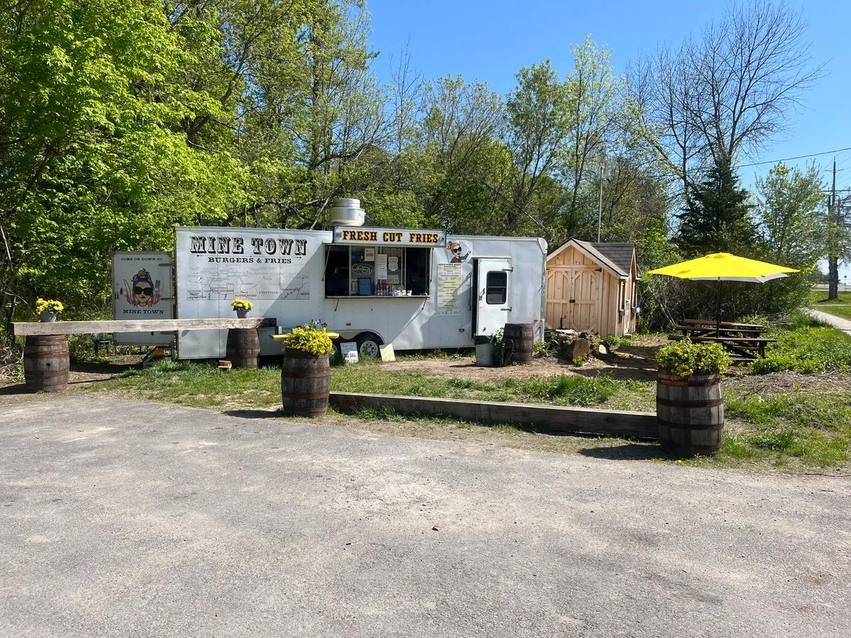 The Mine Town Burgers & Fries truck, with its Fresh Cut Fries window and yellow umbrella seating