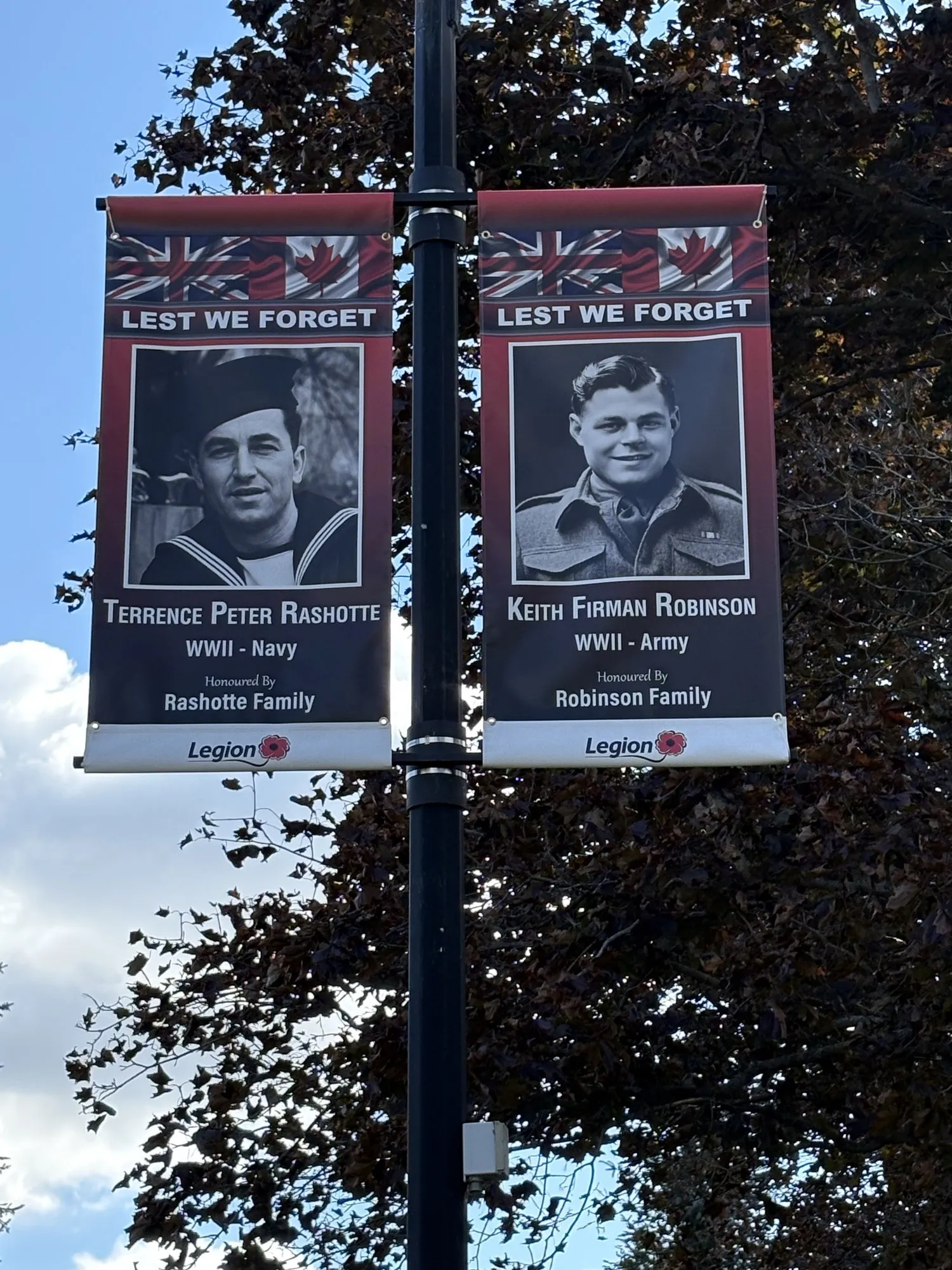 Two Legion Lest We Forget banners on a lamp post in Tweed: Terrence Peter Rashotte, WWII Navy, honoured by the Rashotte family, and Keith Firman Robinson, WWII Army, honoured by the Robinson family.